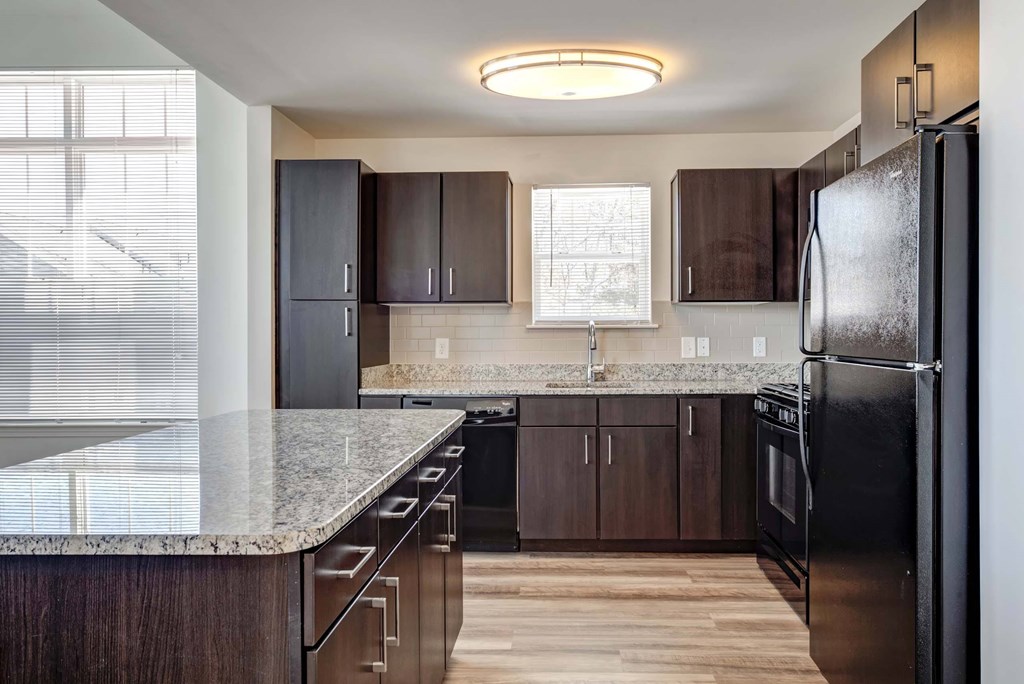 a kitchen with stainless steel appliances and granite counter tops