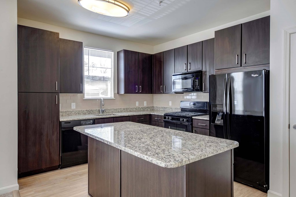 a kitchen with stainless steel appliances and granite counter tops