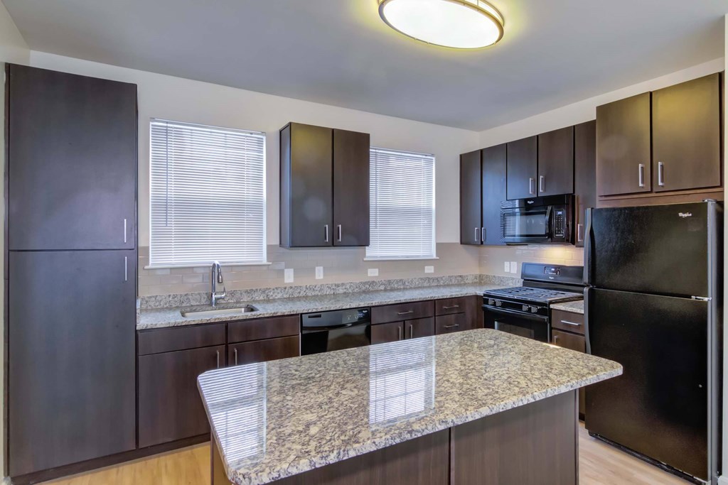 a kitchen with stainless steel appliances and granite counter tops