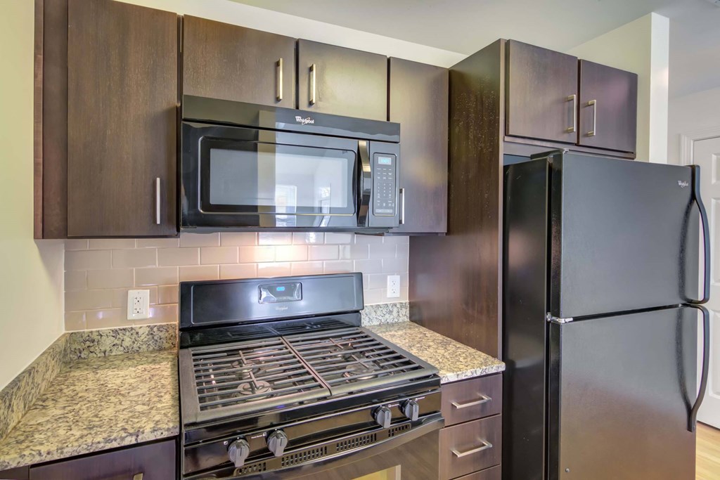a kitchen with stainless steel appliances and granite counter tops