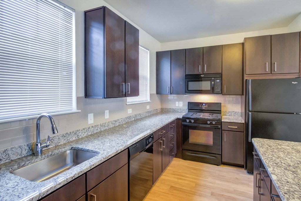 a modern kitchen with granite counter tops and stainless steel appliances