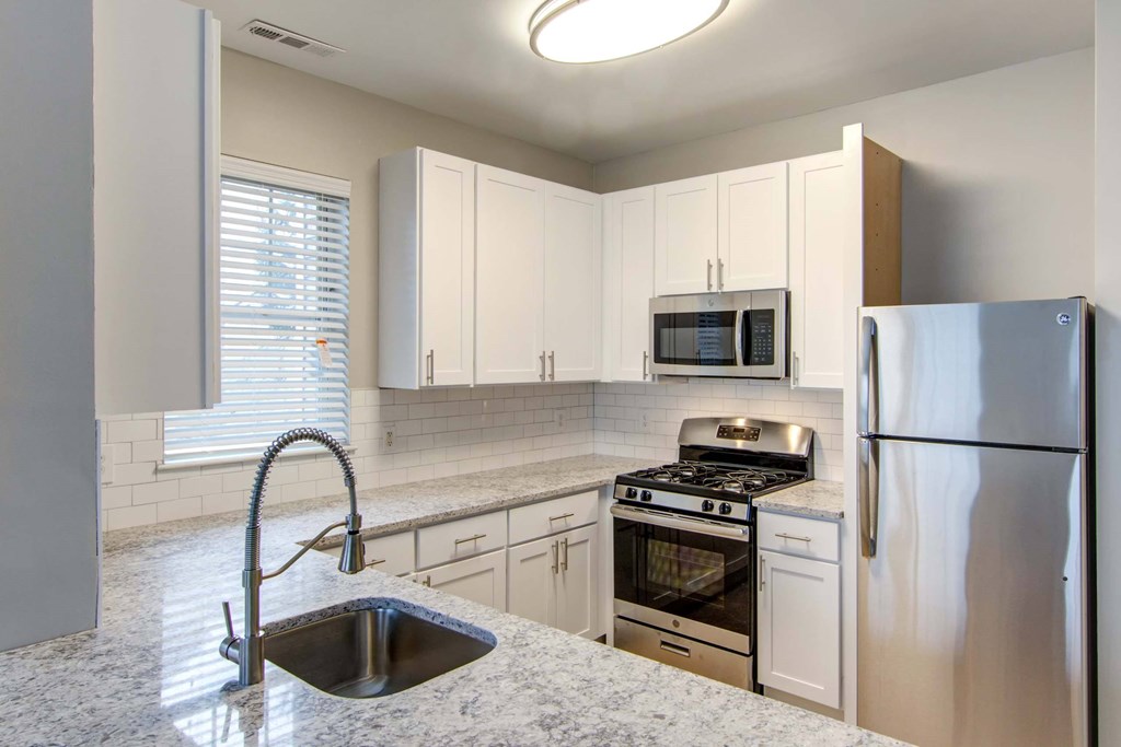 a kitchen with granite counter tops and stainless steel appliances