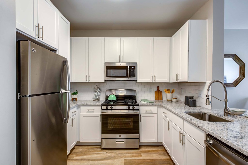 a kitchen with stainless steel appliances and white cabinets