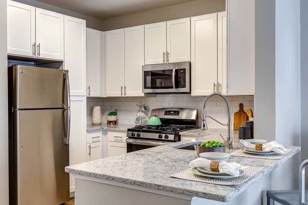 a kitchen with stainless steel appliances and granite counter tops