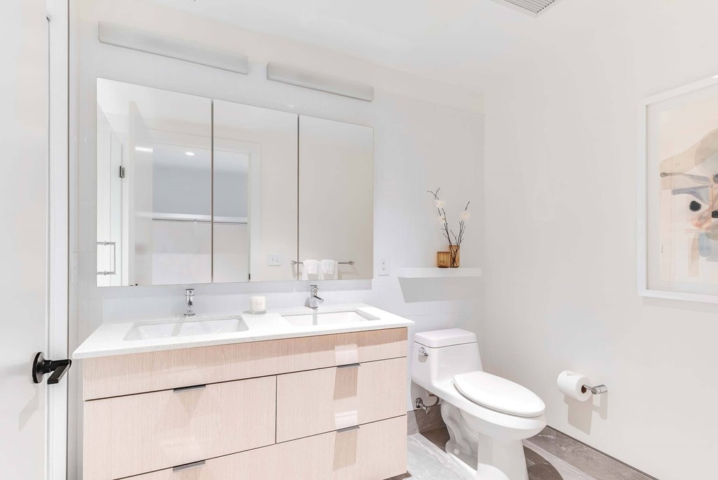 a bathroom with a toilet sink and mirror