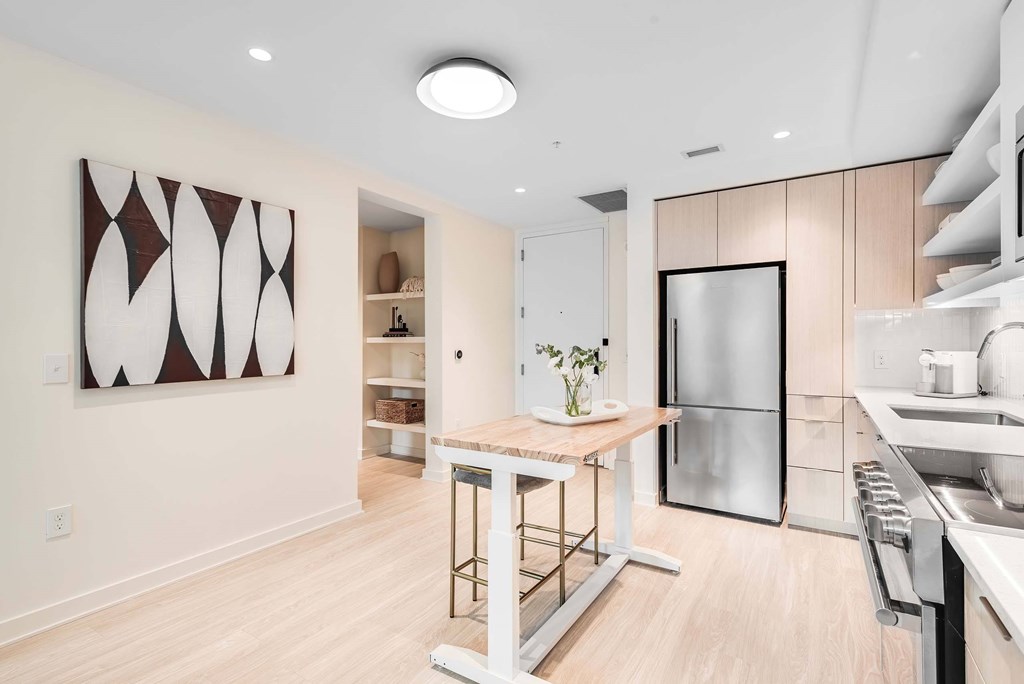 a kitchen with wood floors and white walls