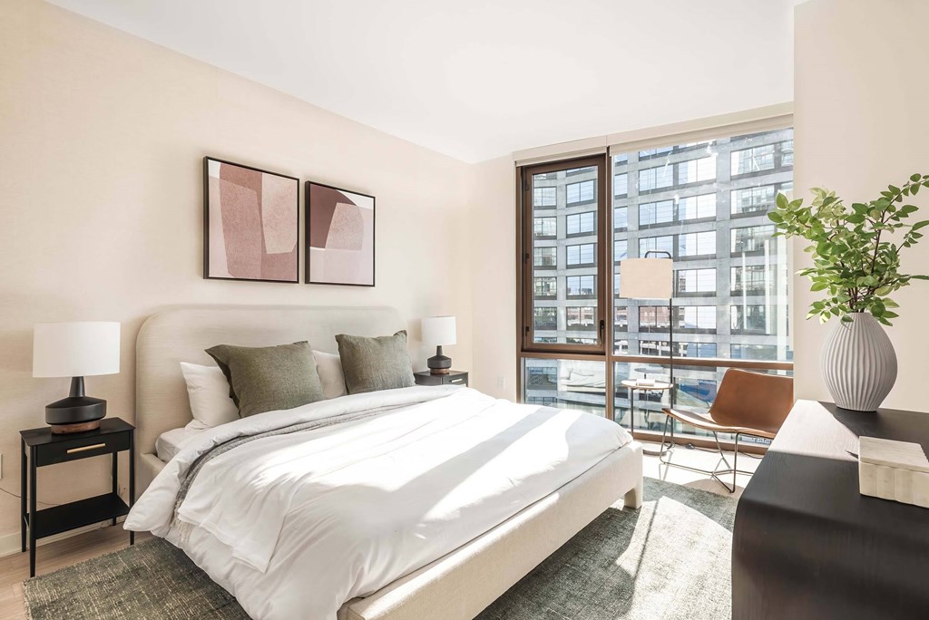 a bedroom with a large bed and a large window