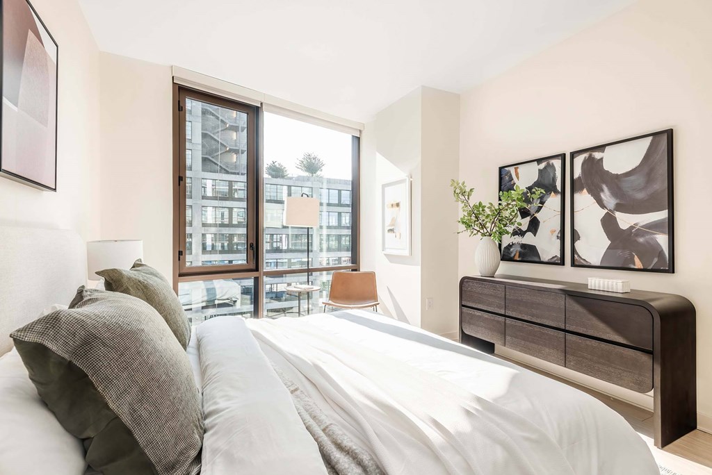 a bedroom with a large bed and a large window