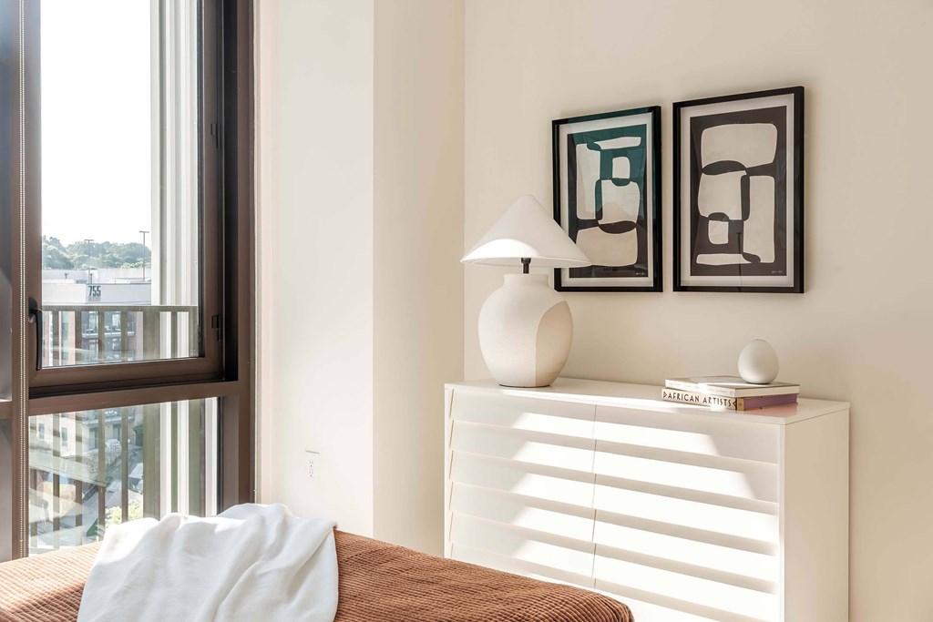 a bedroom with a bed and a window