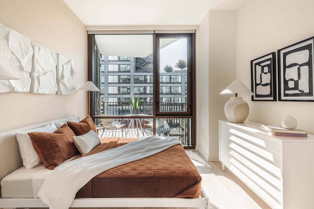 a bedroom with a large bed and a large window