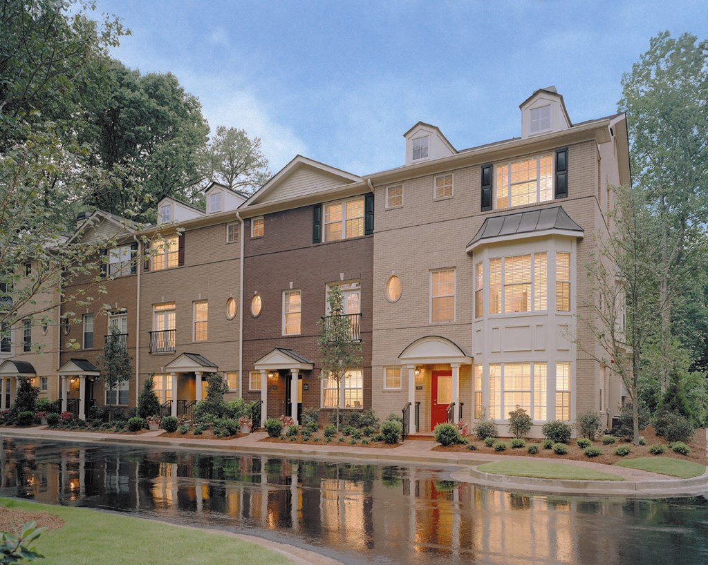a large building with a lake in front of it