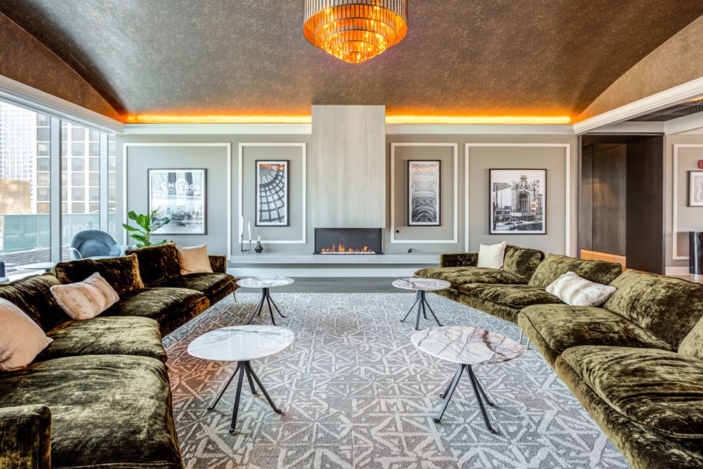 a living room with couches and tables and a fireplace