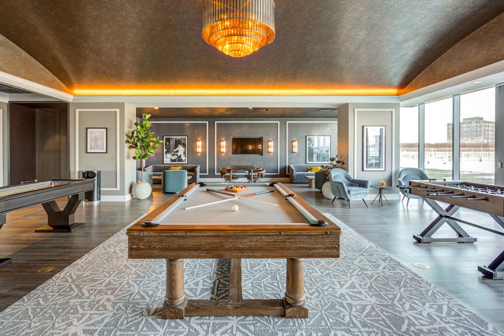 a billiards room with a pool table in the middle