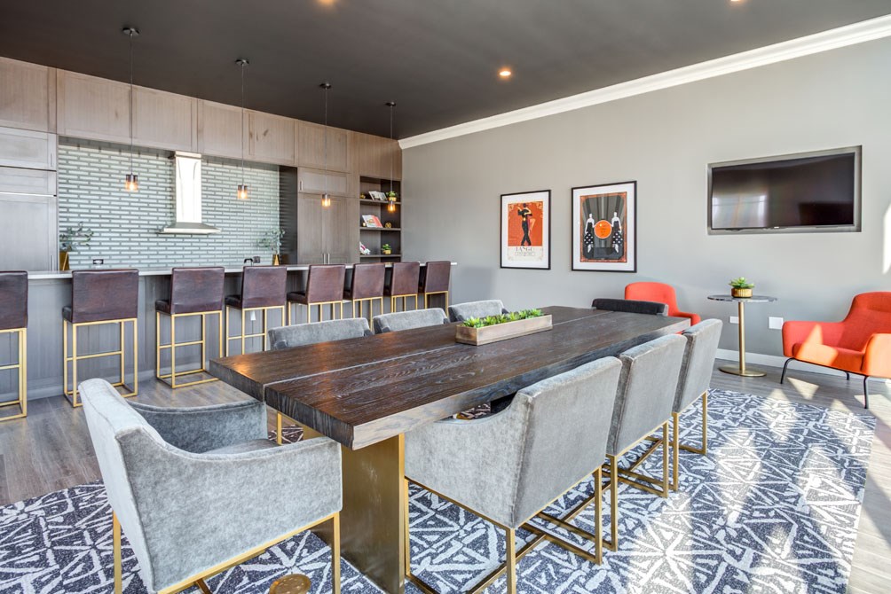a conference room with a long table and chairs and a television