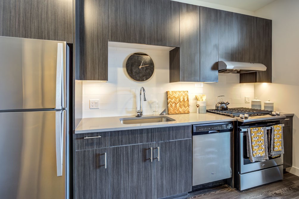 a kitchen with stainless steel appliances and a stainless steel refrigerator