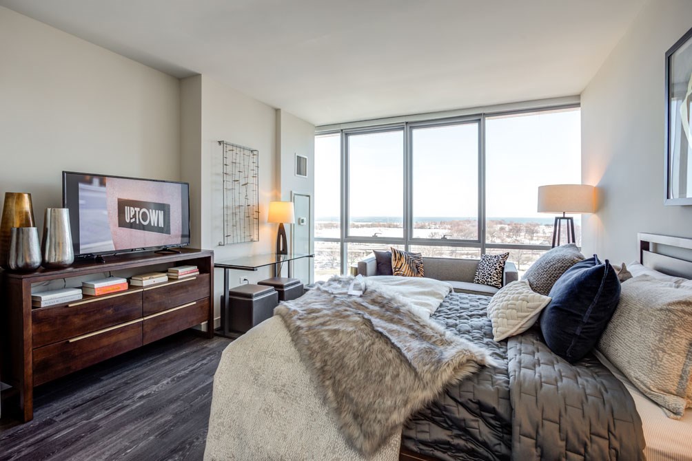 a bedroom with a large bed and a television