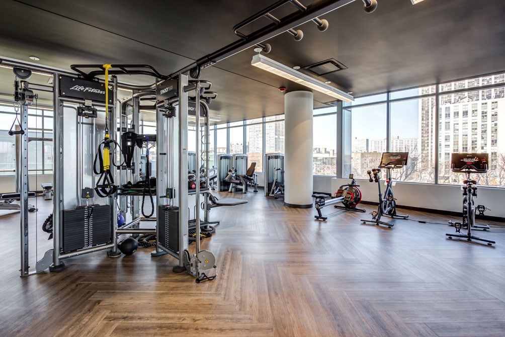 a workout room with gym equipment and a view of the city