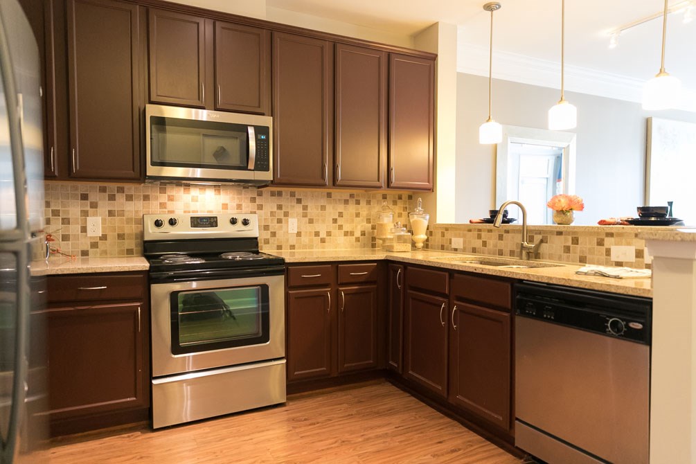 a kitchen with stainless steel appliances and brown cabinets