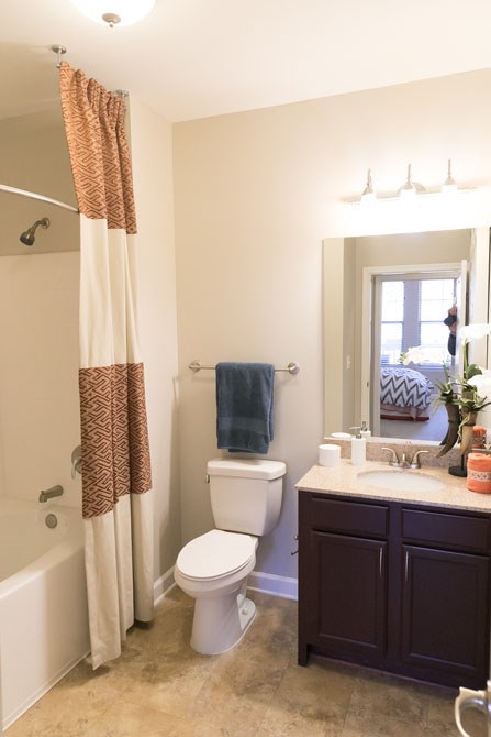 a bathroom with a toilet and a sink and a shower