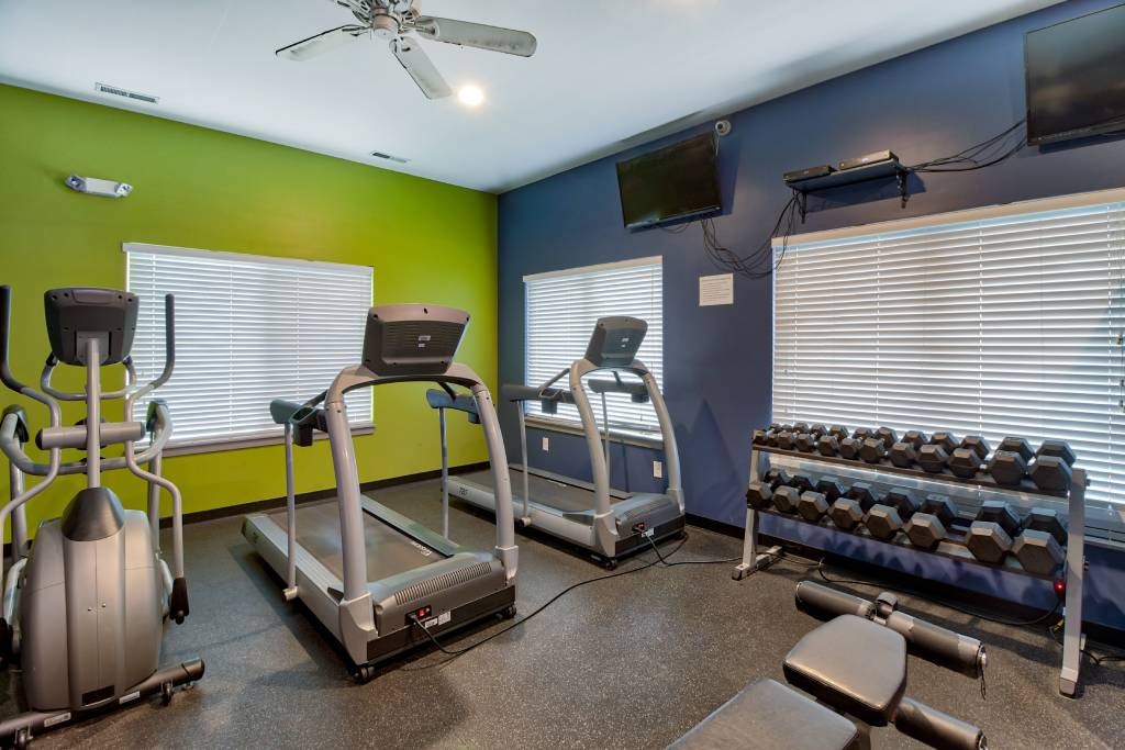 a gym with treadmills and other exercise equipment