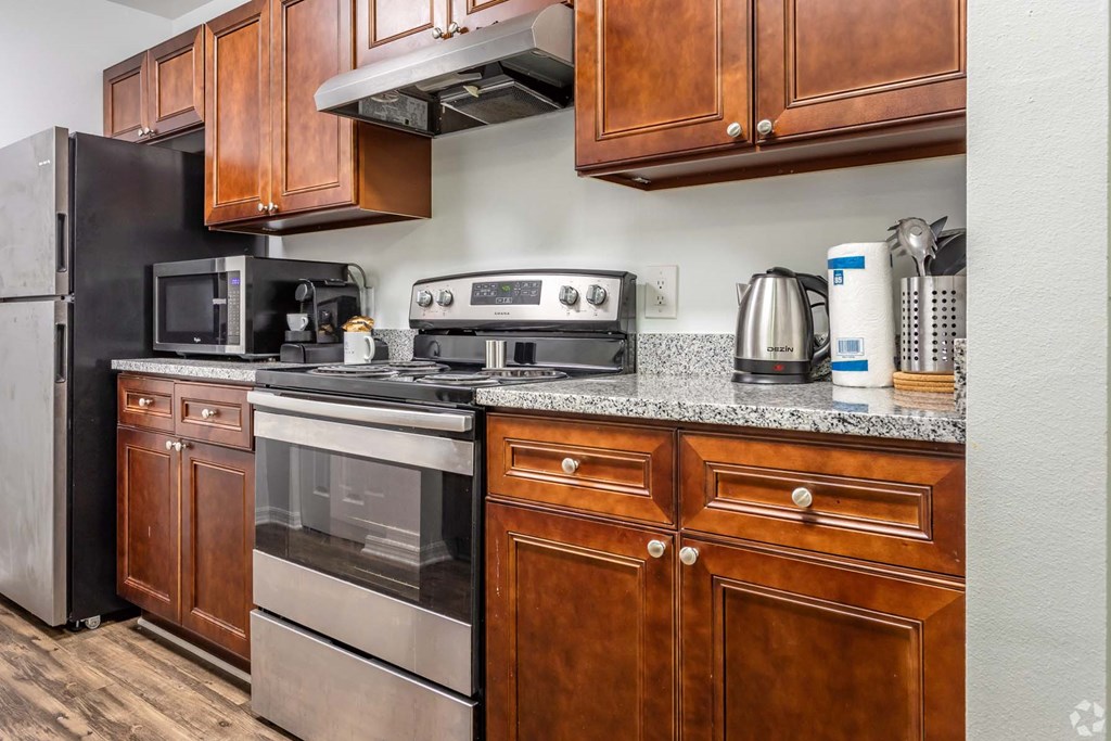 a kitchen with stainless steel appliances and wooden cabinets