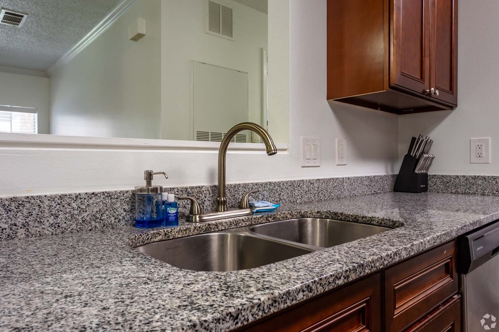 a kitchen with granite counter tops and a sink