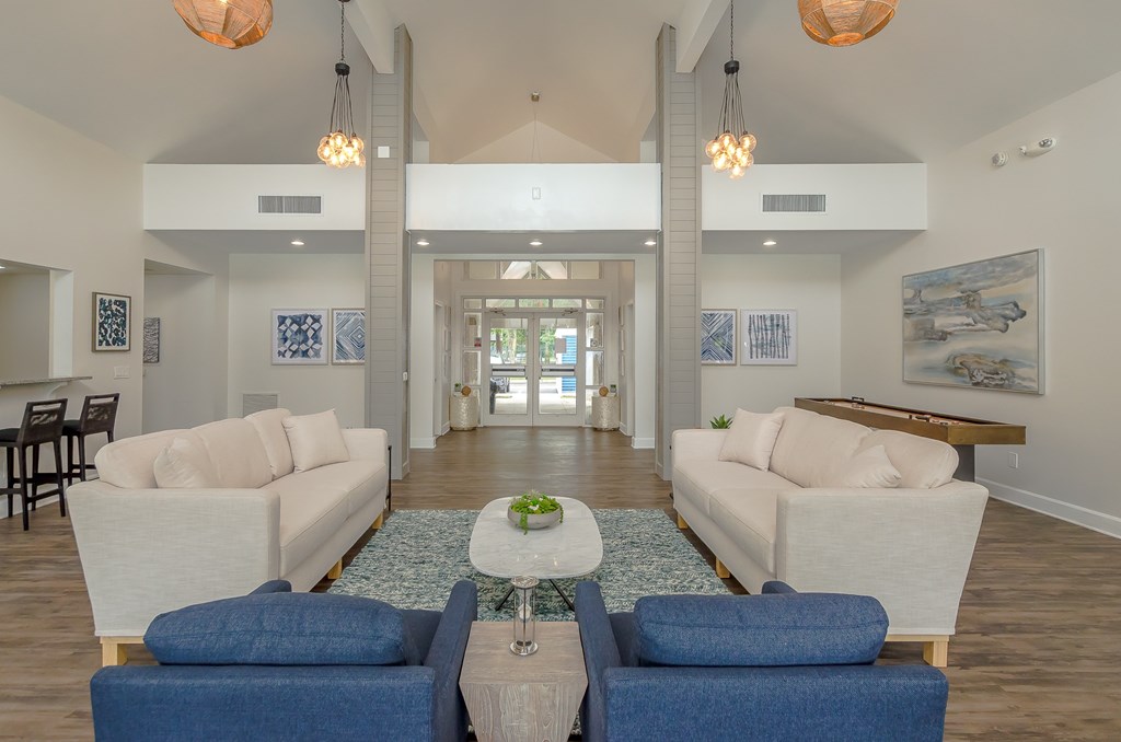 a living room with couches and chairs and a table