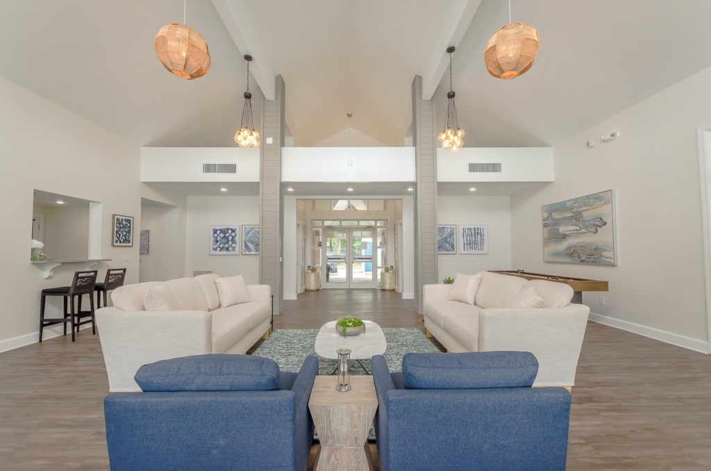a living room with couches and chairs and a coffee table