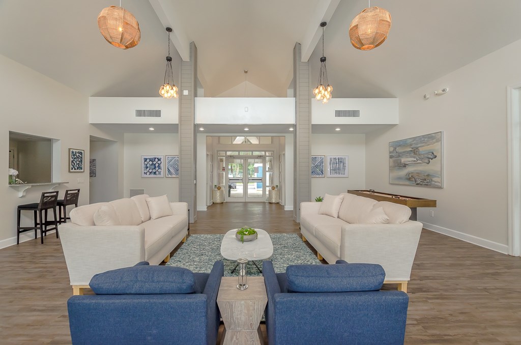 a living room with couches and chairs and a table