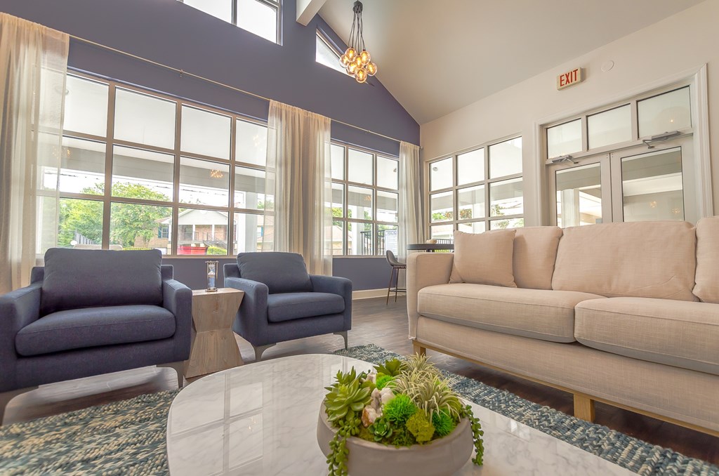 a living room with a couch and chairs and a table