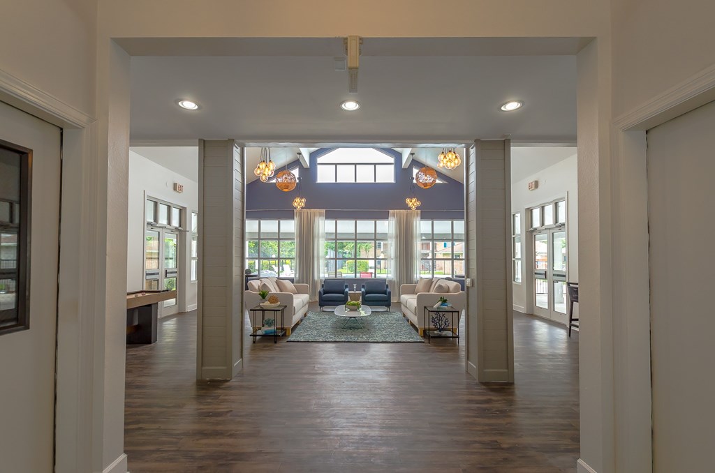 a hallway with geometric patterns on the ceiling and a wood floor