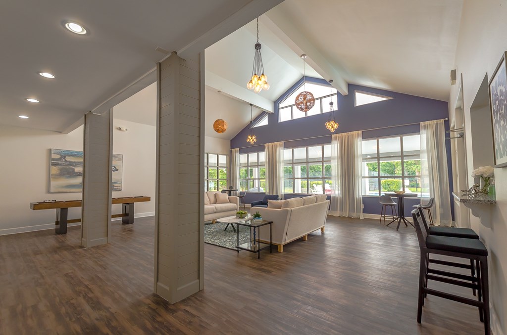 a living room with couches and chairs and a table