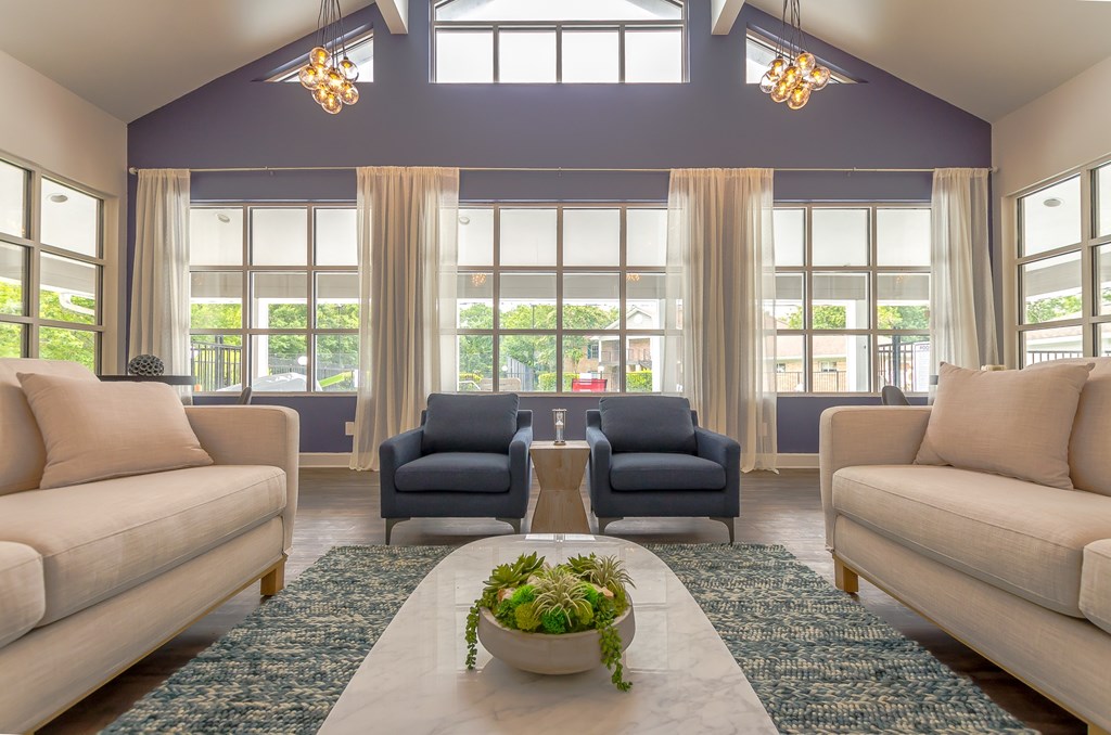 a living room with couches and chairs and a table