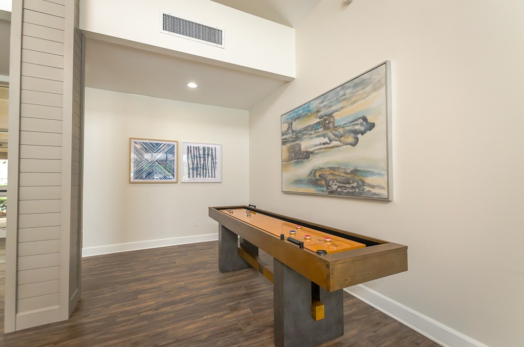 a game room with a pool table and a painting