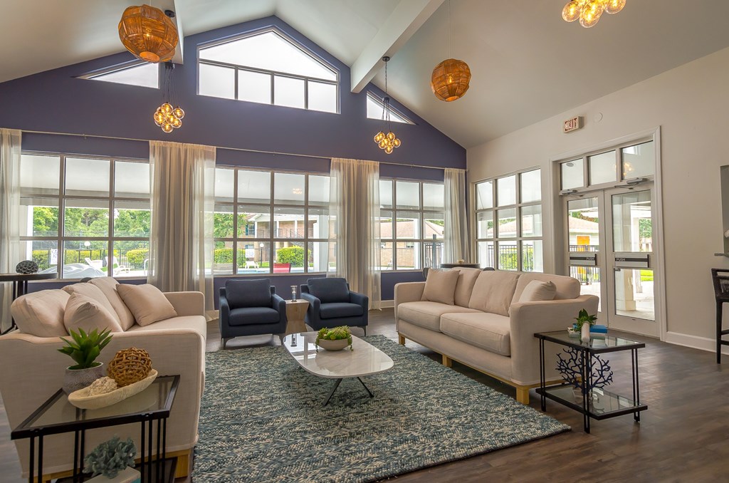 a living room with couches and chairs and a rug