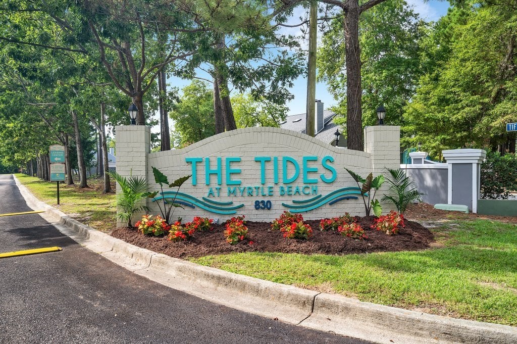 the tides sign at the entrance to the tidelands park