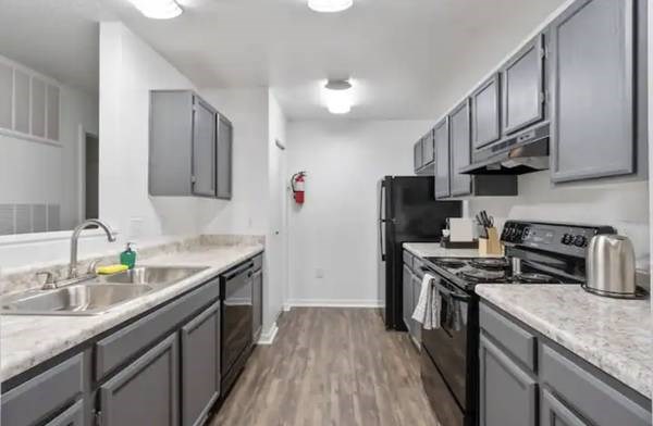 a kitchen with stainless steel appliances and marble counter tops