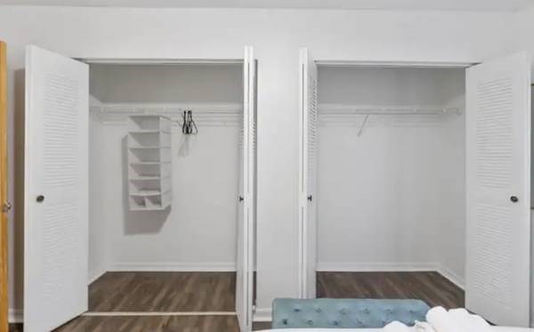 a white room with a closet and a mirrored door