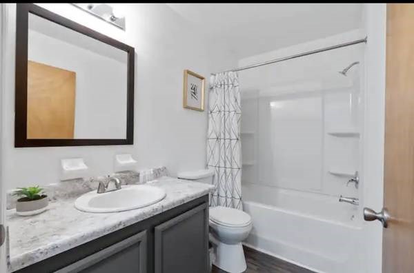 a bathroom with a sink toilet and a shower