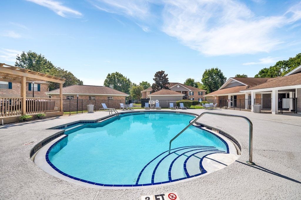 a resort style pool with buildings in the background