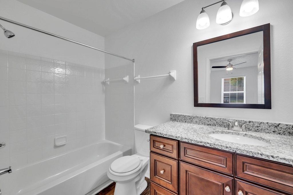 a bathroom with a shower toilet and sink