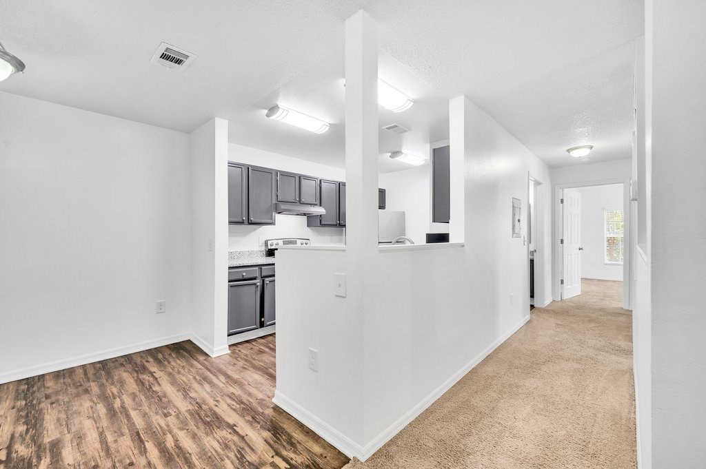 a renovated apartment with a kitchen and a hallway