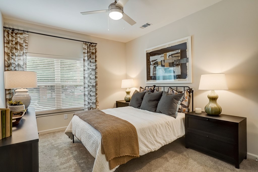 a bedroom with a bed and a ceiling fan
