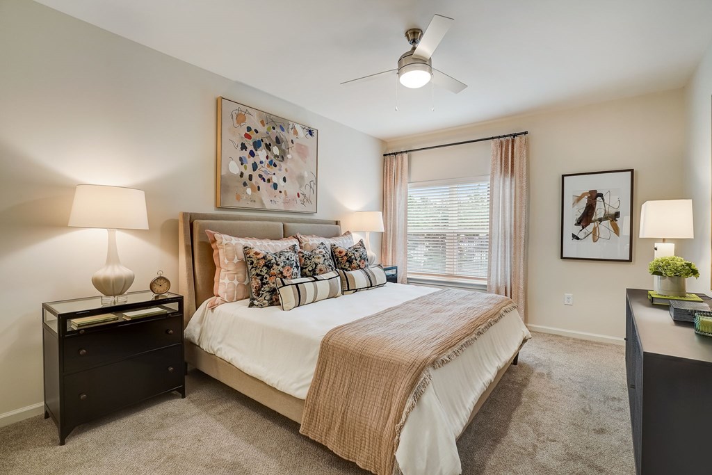 a bedroom with a large bed and a window