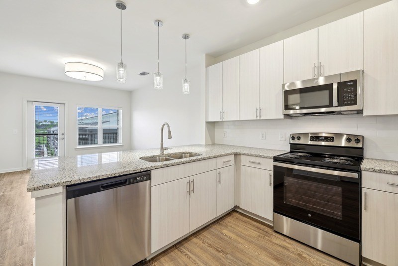a kitchen with stainless steel appliances and white cabinets