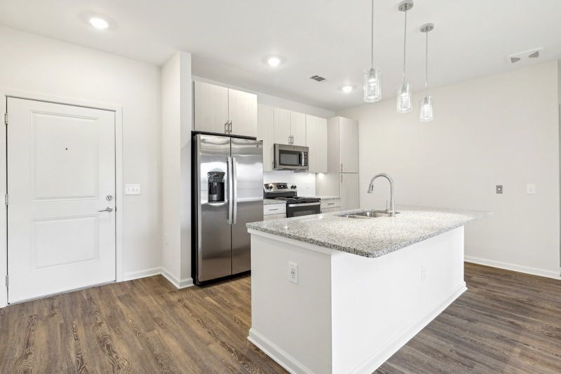 a kitchen with a counter top and a refrigerator