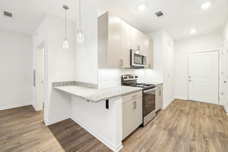 a kitchen with white cabinets and a counter top