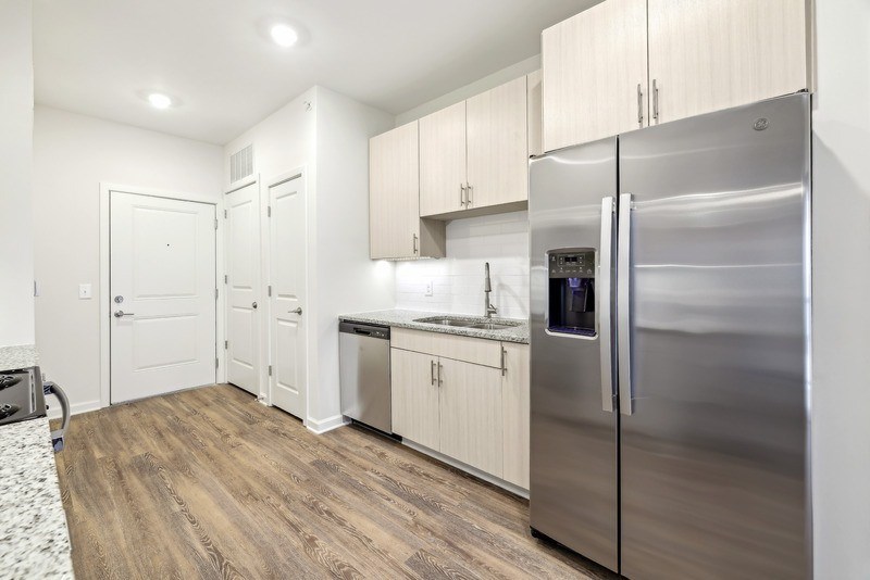 a kitchen with stainless steel appliances and white cabinets