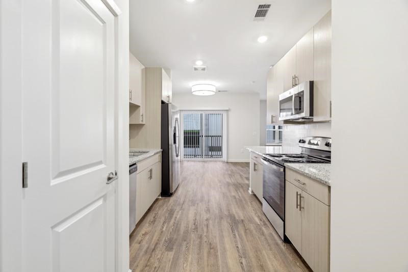 a large kitchen with a stove and a sink