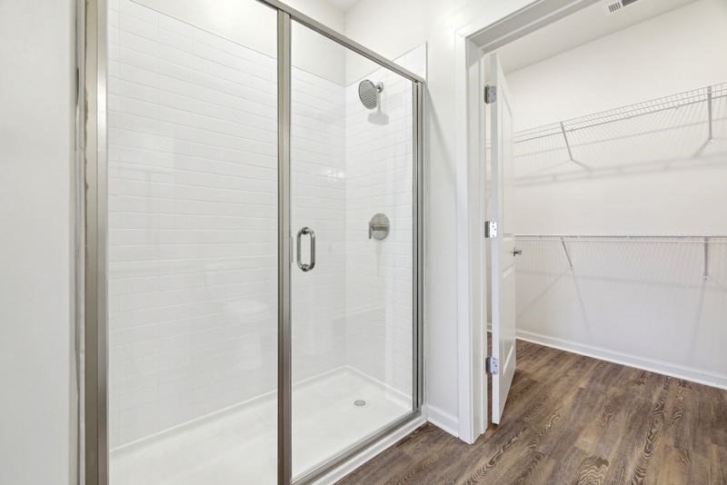 a bathroom with a shower with a glass door